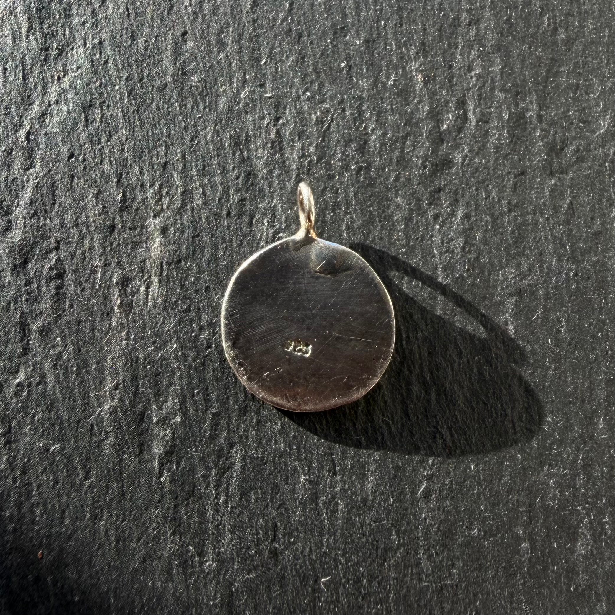 Back of handcrafted sterling silver Eye of Horus talisman pendant showing maker’s mark