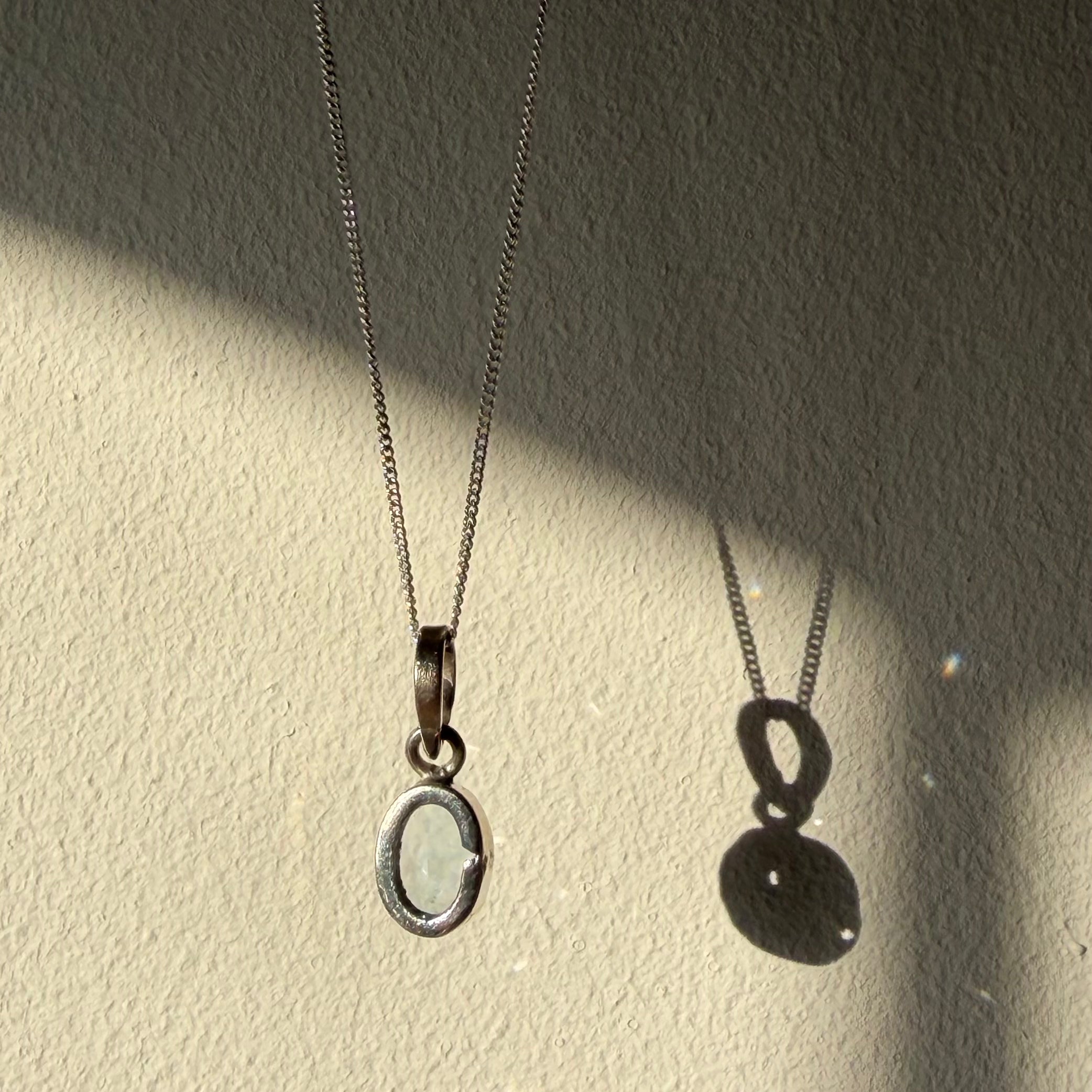 open back design on blue topaz gemstone pendant