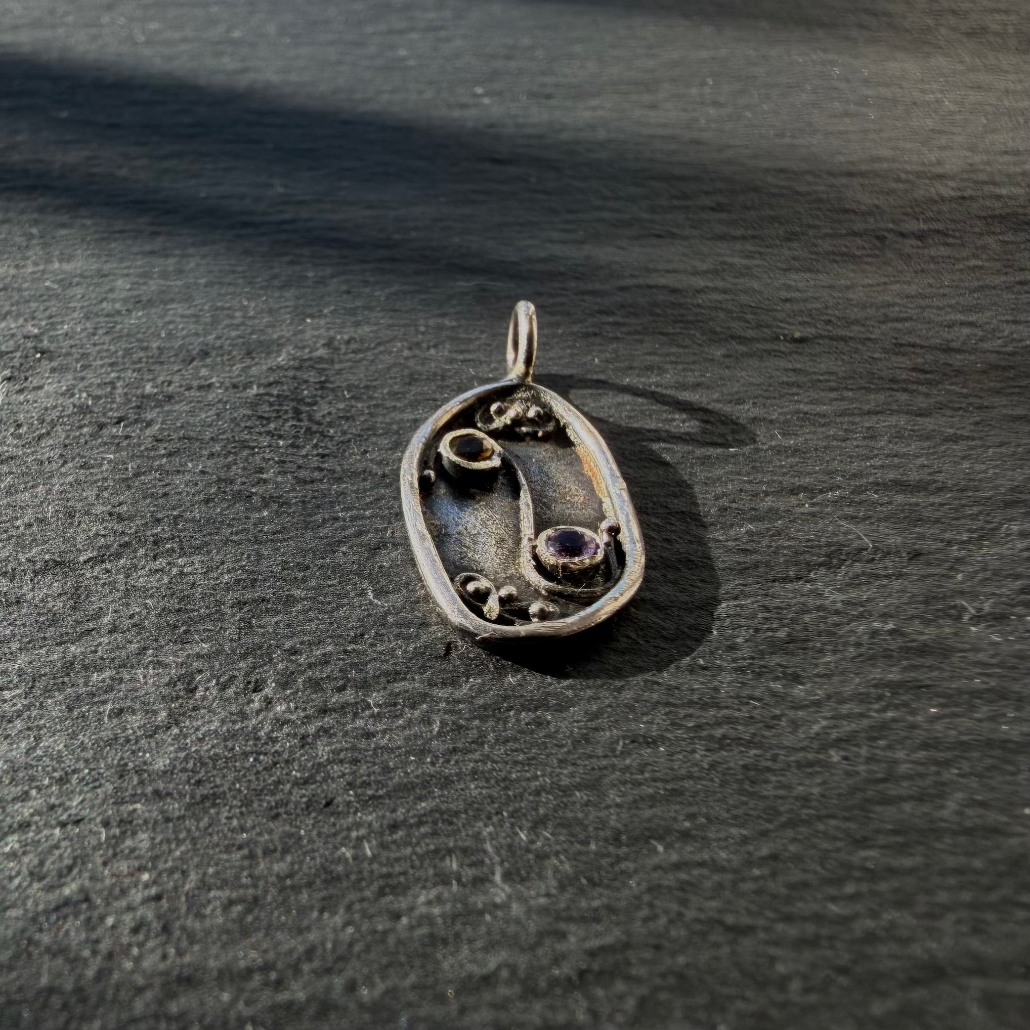 Side detail of sterling silver Yin Yang talisman pendant with citrine and amethyst
