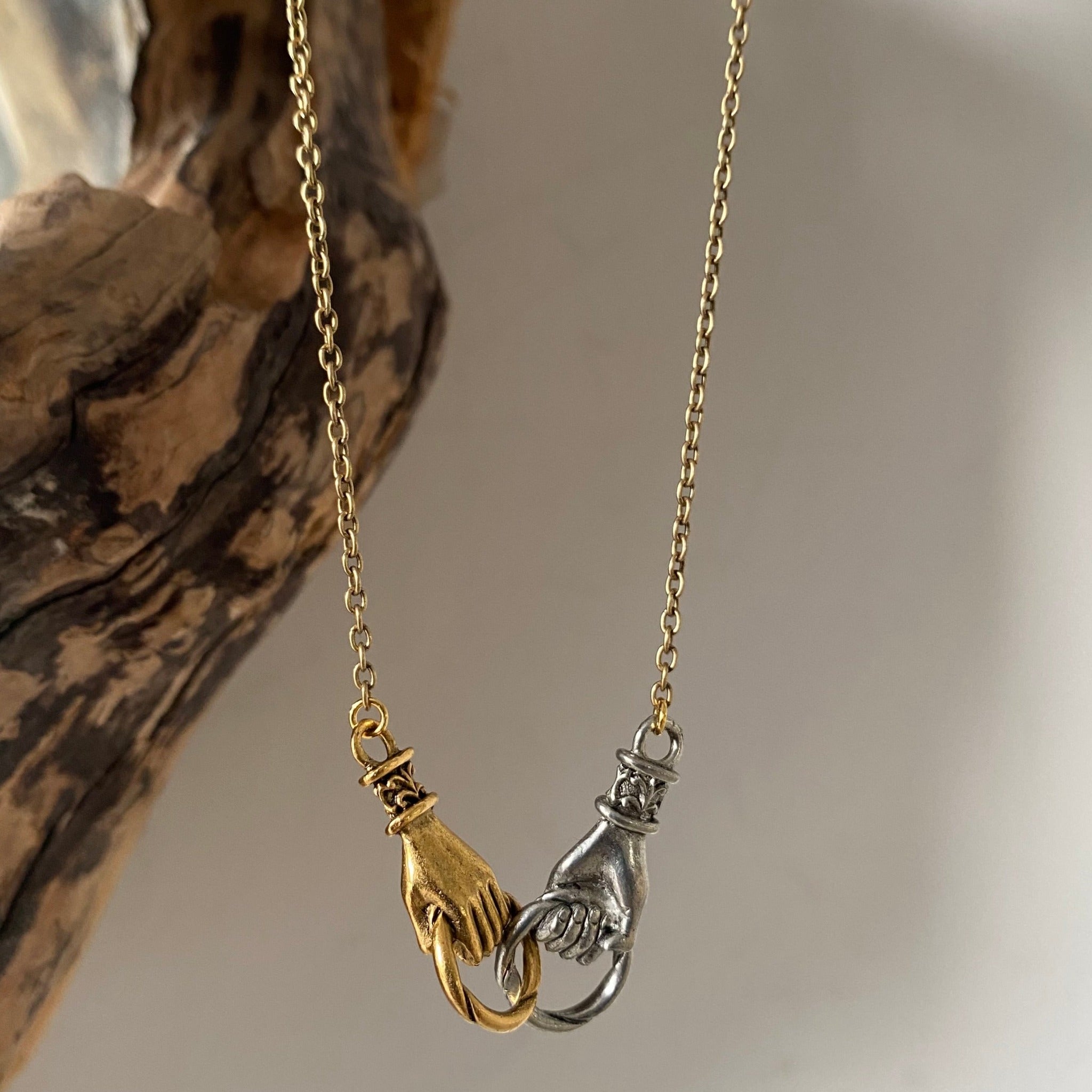mixed metal hands necklace