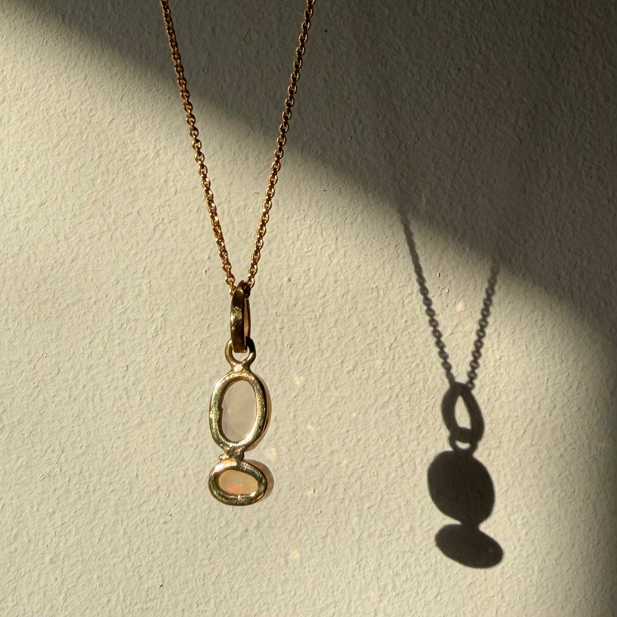 open back design of rose quartz and opal gold pendant
