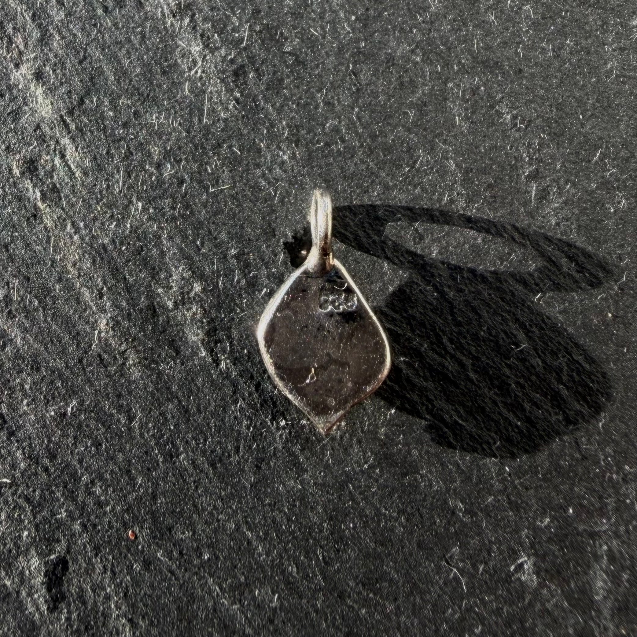 Back of handcrafted sterling silver petite eye talisman pendant with maker’s mark