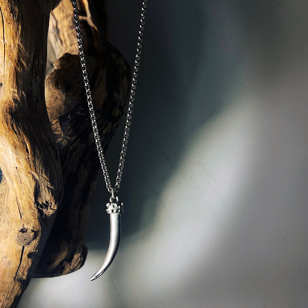 antique silver cast tusk pendant