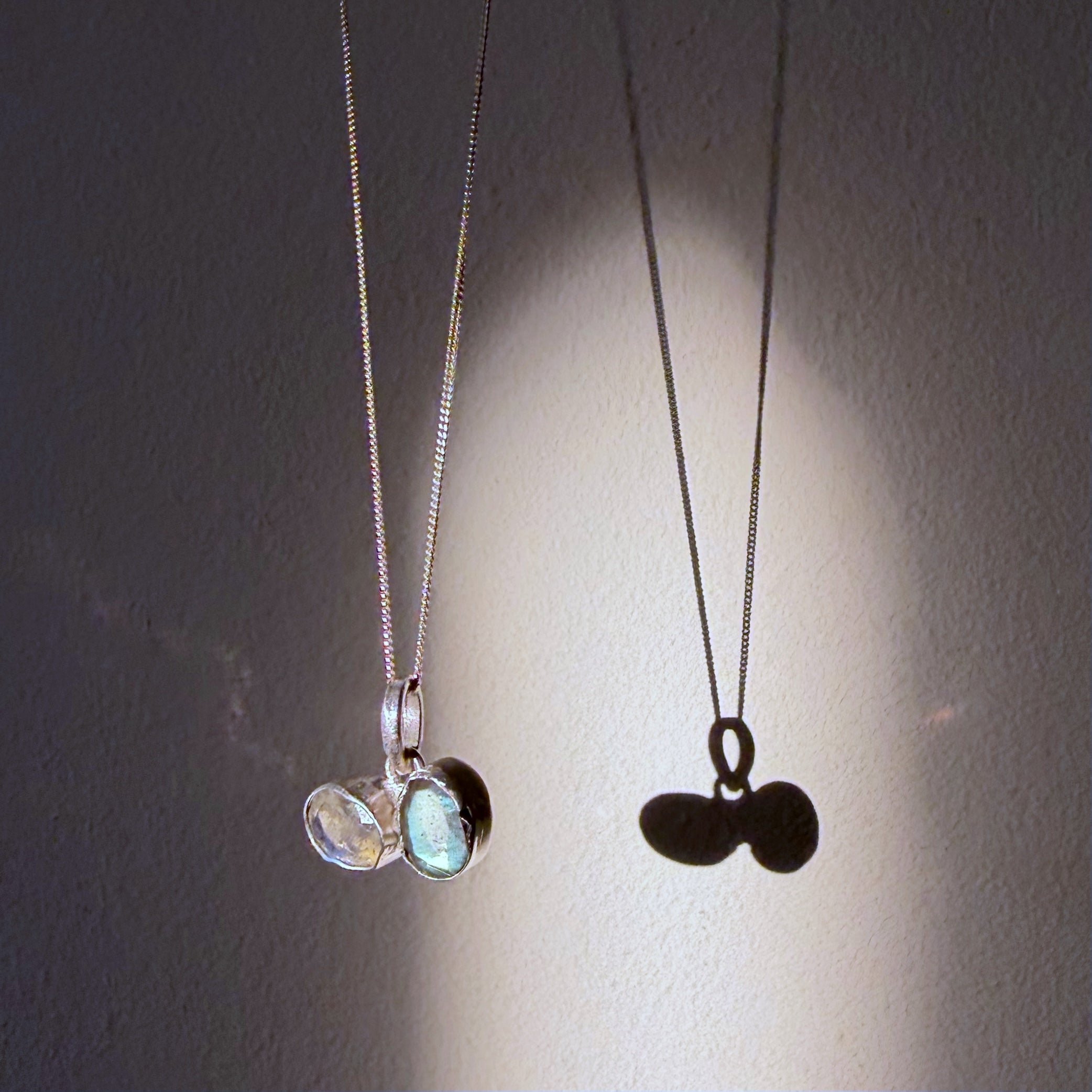 toi et moi labradorite silver pendant hanging in daylight