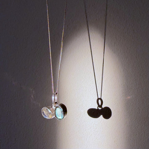 toi et moi labradorite silver pendant hanging in daylight