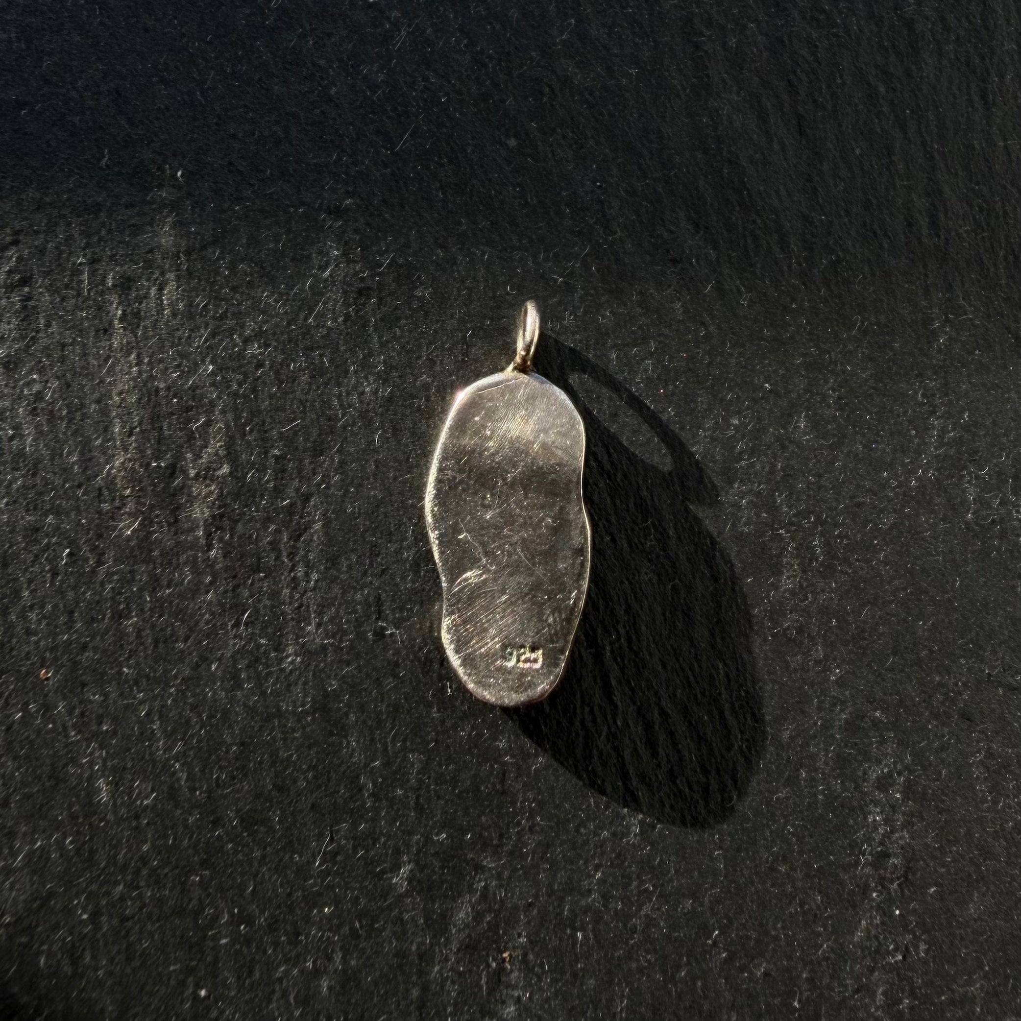 Back of handcrafted sterling silver yin yang pendant with amethyst and peridot