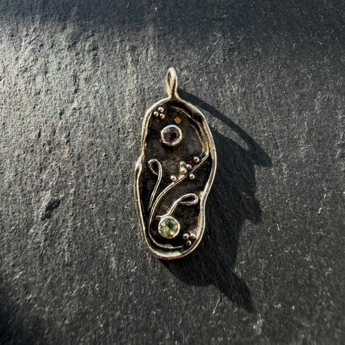 Handcrafted sterling silver yin yang pendant with amethyst and peridot gemstones