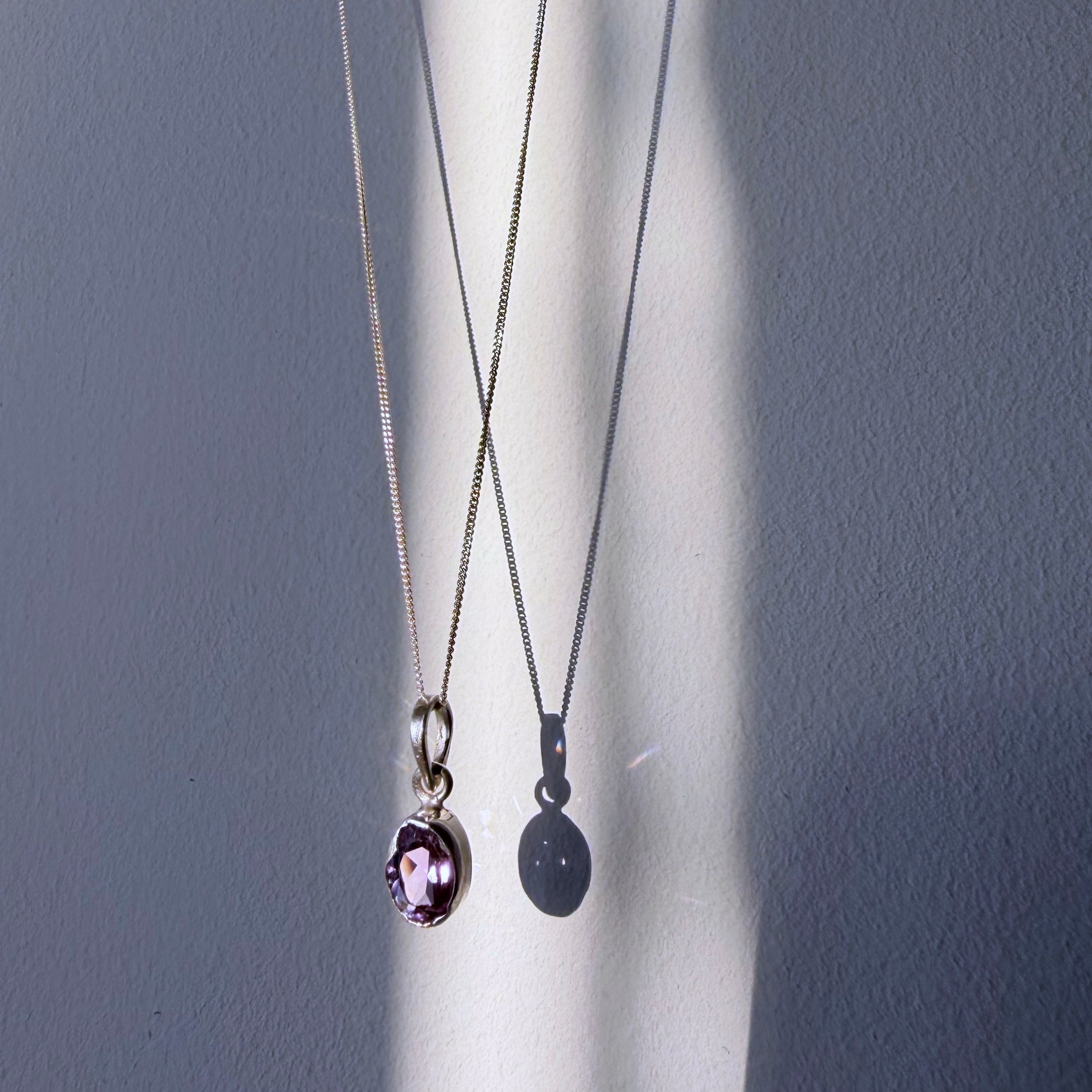 amethyst sterling silver pendant hanging in daylight