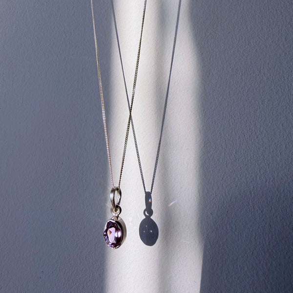 amethyst sterling silver pendant hanging in daylight