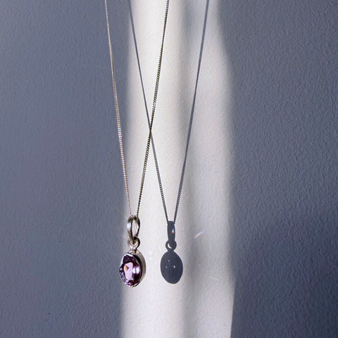 amethyst sterling silver pendant hanging in daylight