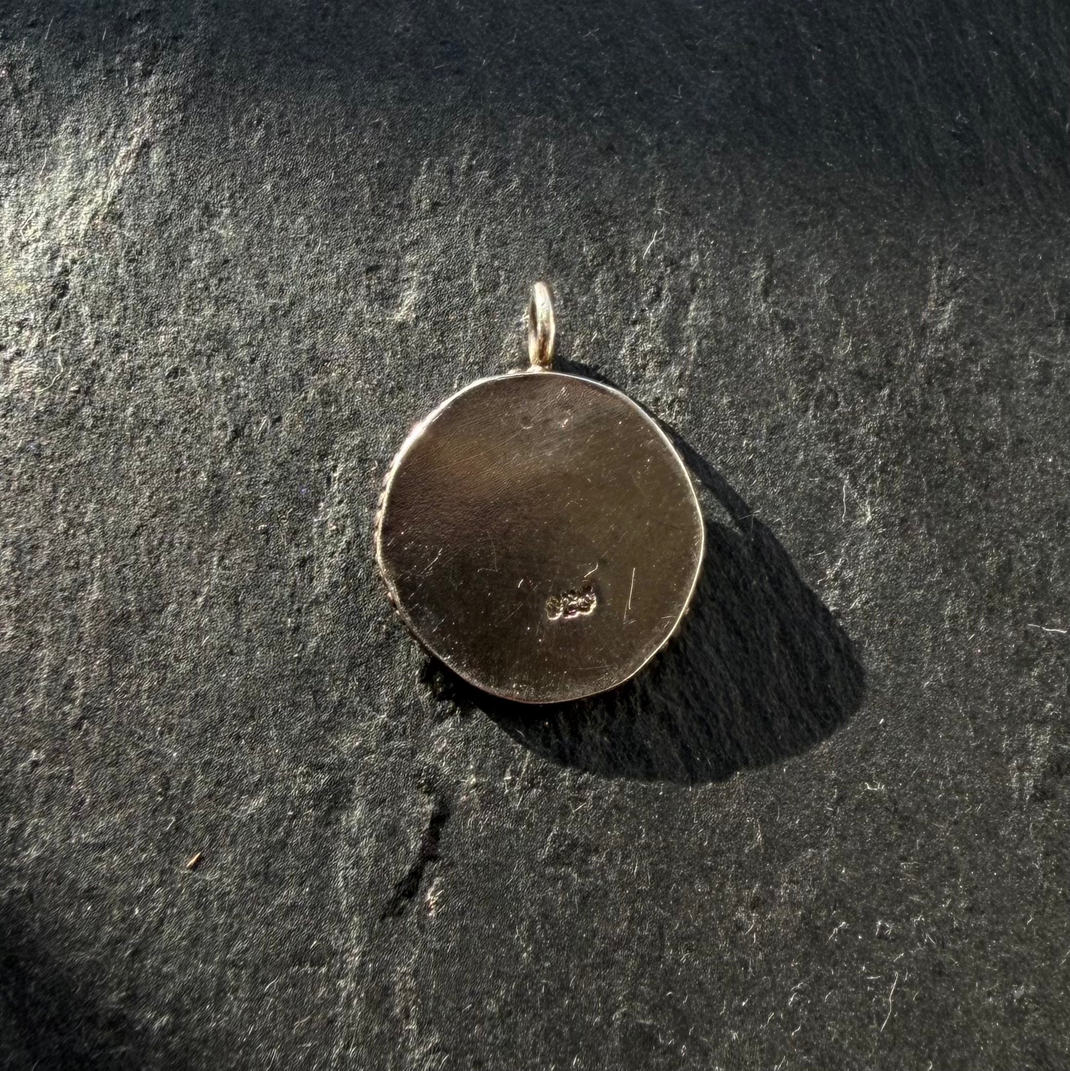 Back of handcrafted sterling silver Eye of Ra talisman pendant with maker’s mark