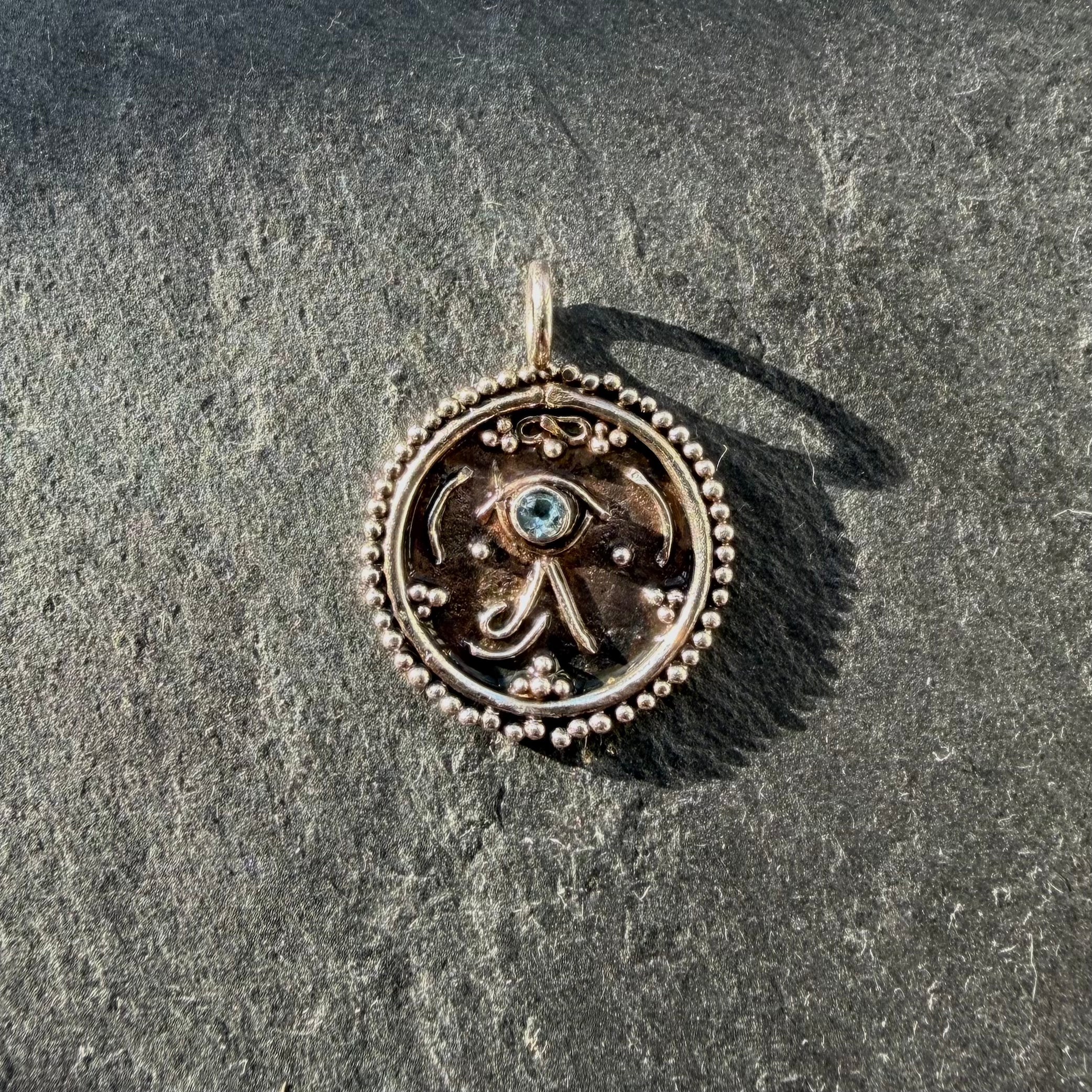 Handcrafted sterling silver Eye of Ra talisman pendant with aquamarine gemstone
