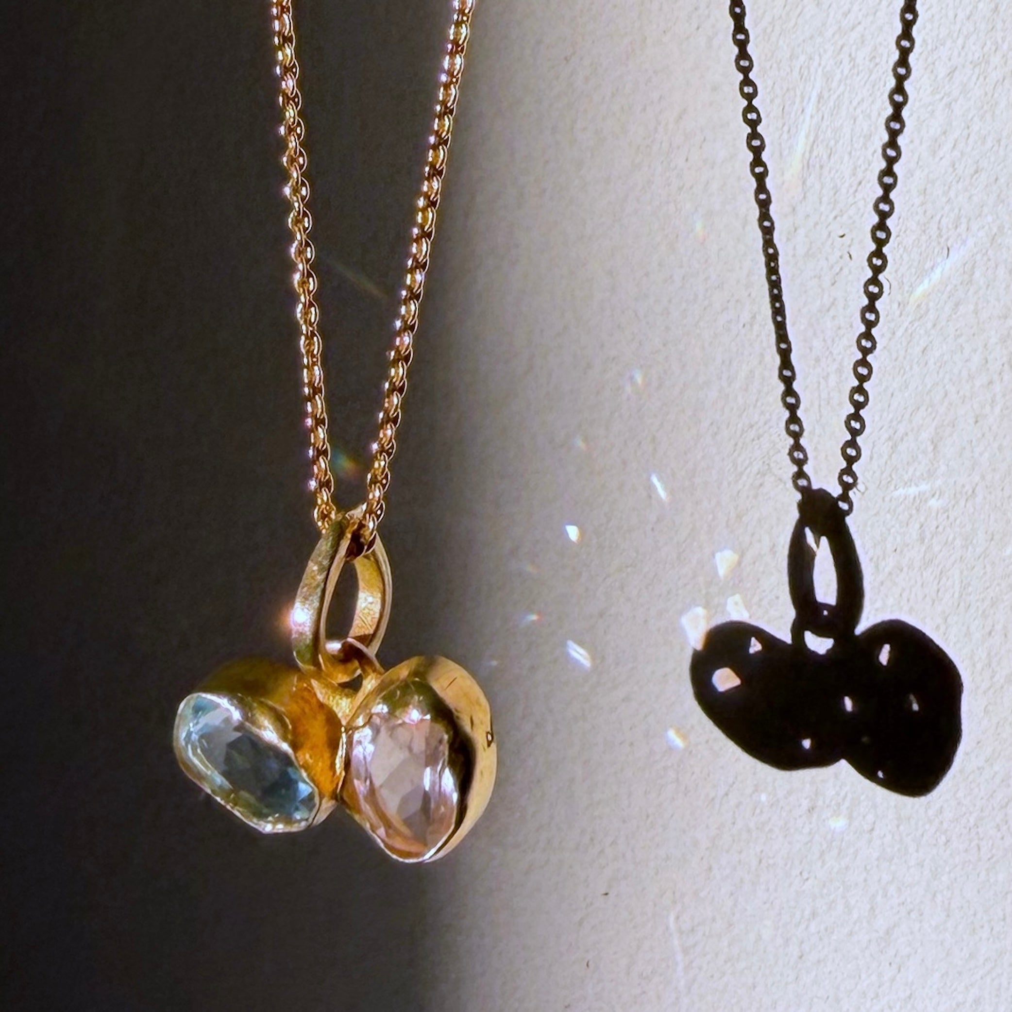 blue topaz and rose quartz gold pendant close up