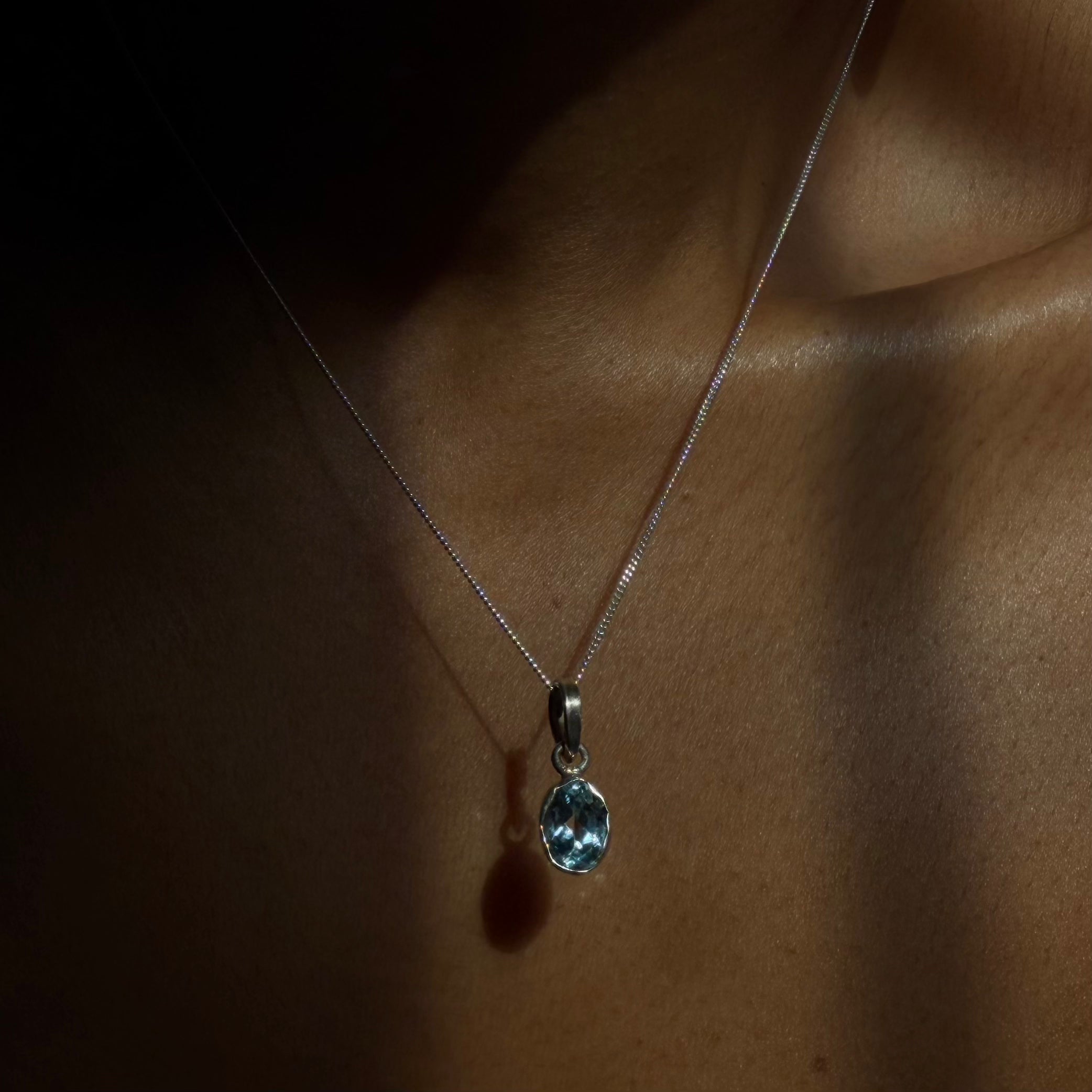 sterling silver blue topaz pendant on wearing