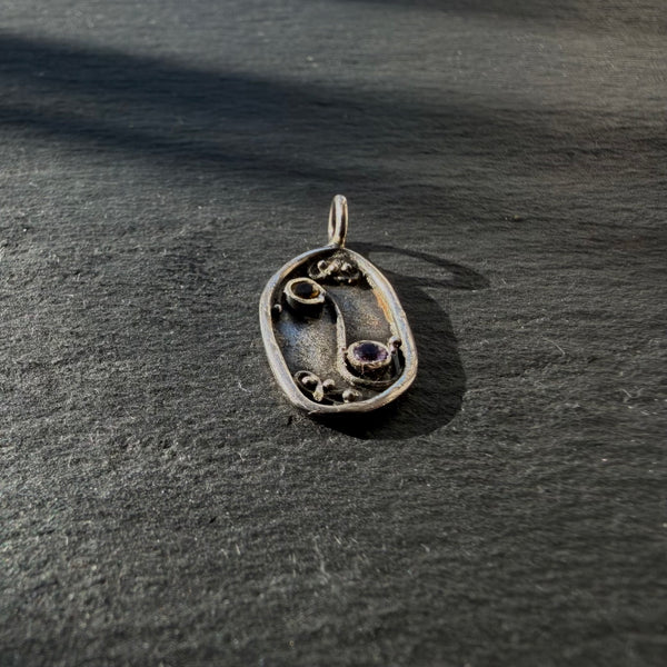 Side detail of sterling silver Yin Yang talisman pendant with citrine and amethyst