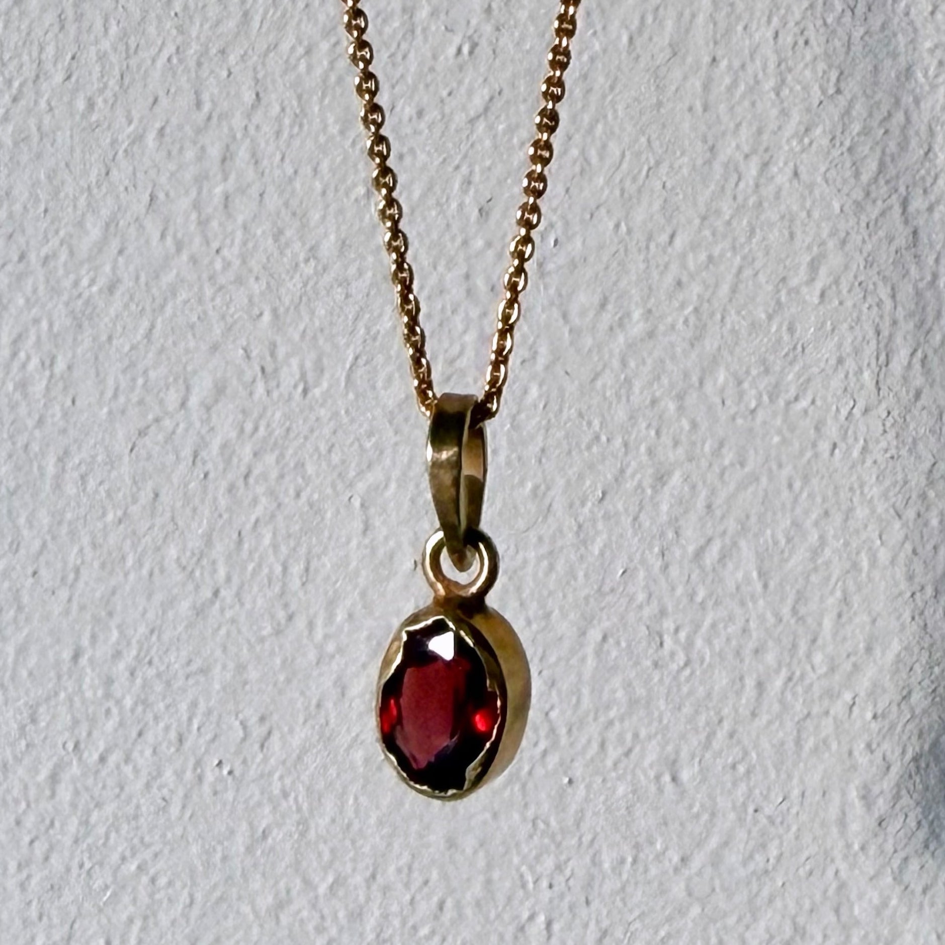 garnet gold pendant up close