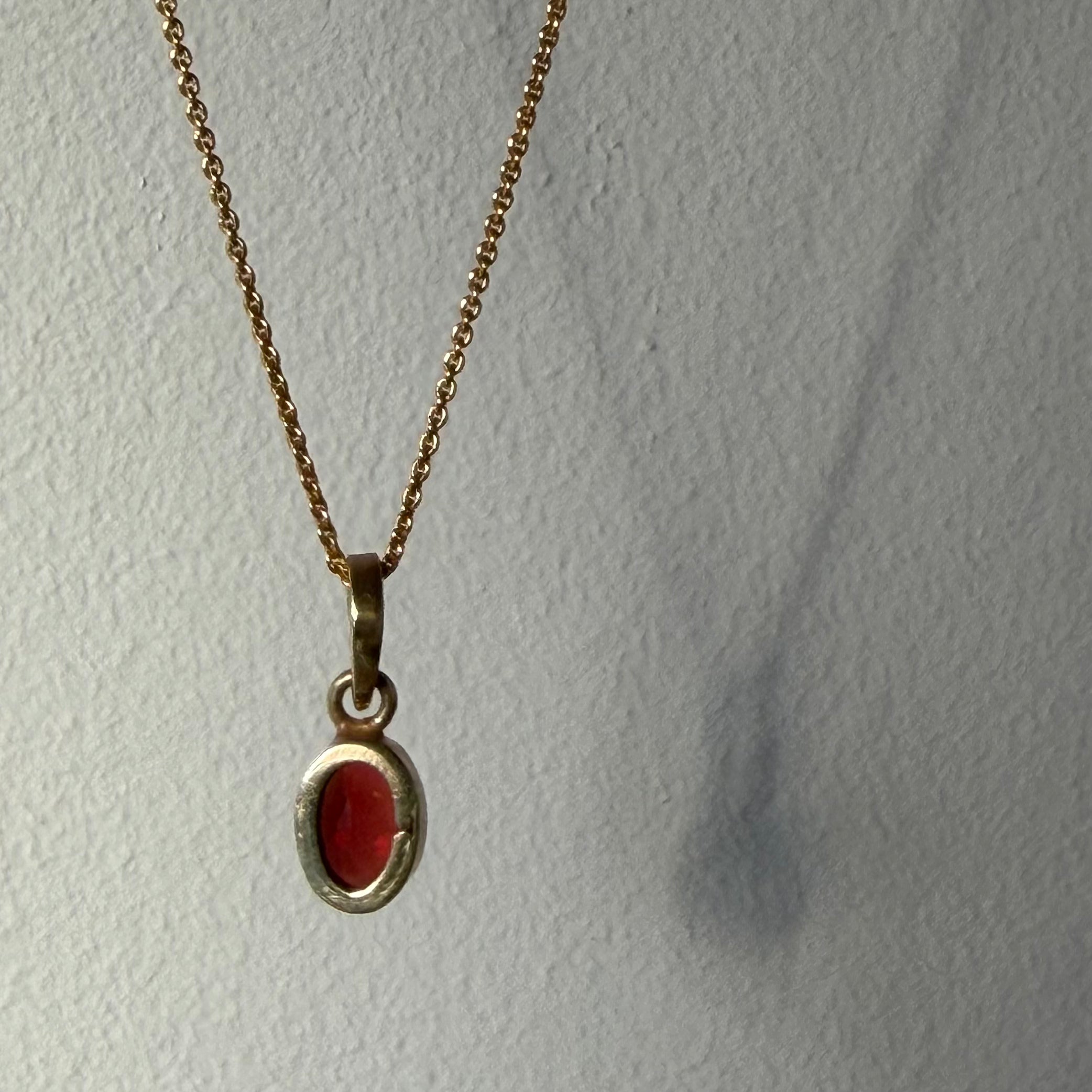 back detail of garnet gold pendant