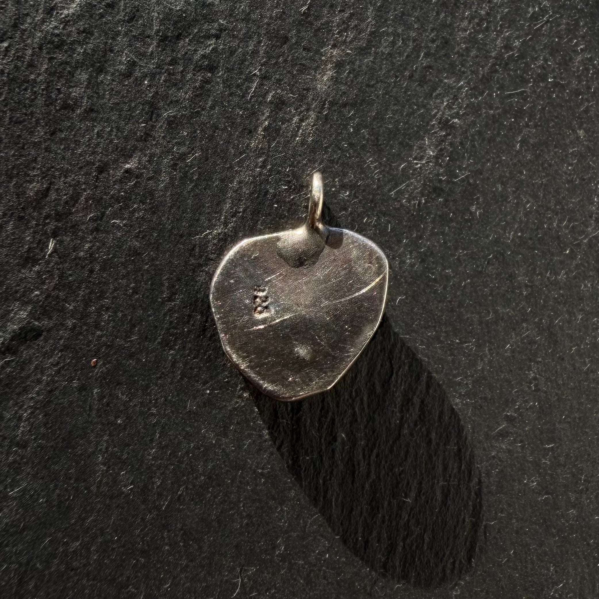 Back of handcrafted sterling silver pyrite evil eye shell pendant