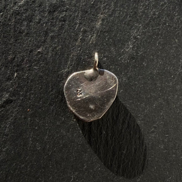 Back of handcrafted sterling silver pyrite evil eye shell pendant