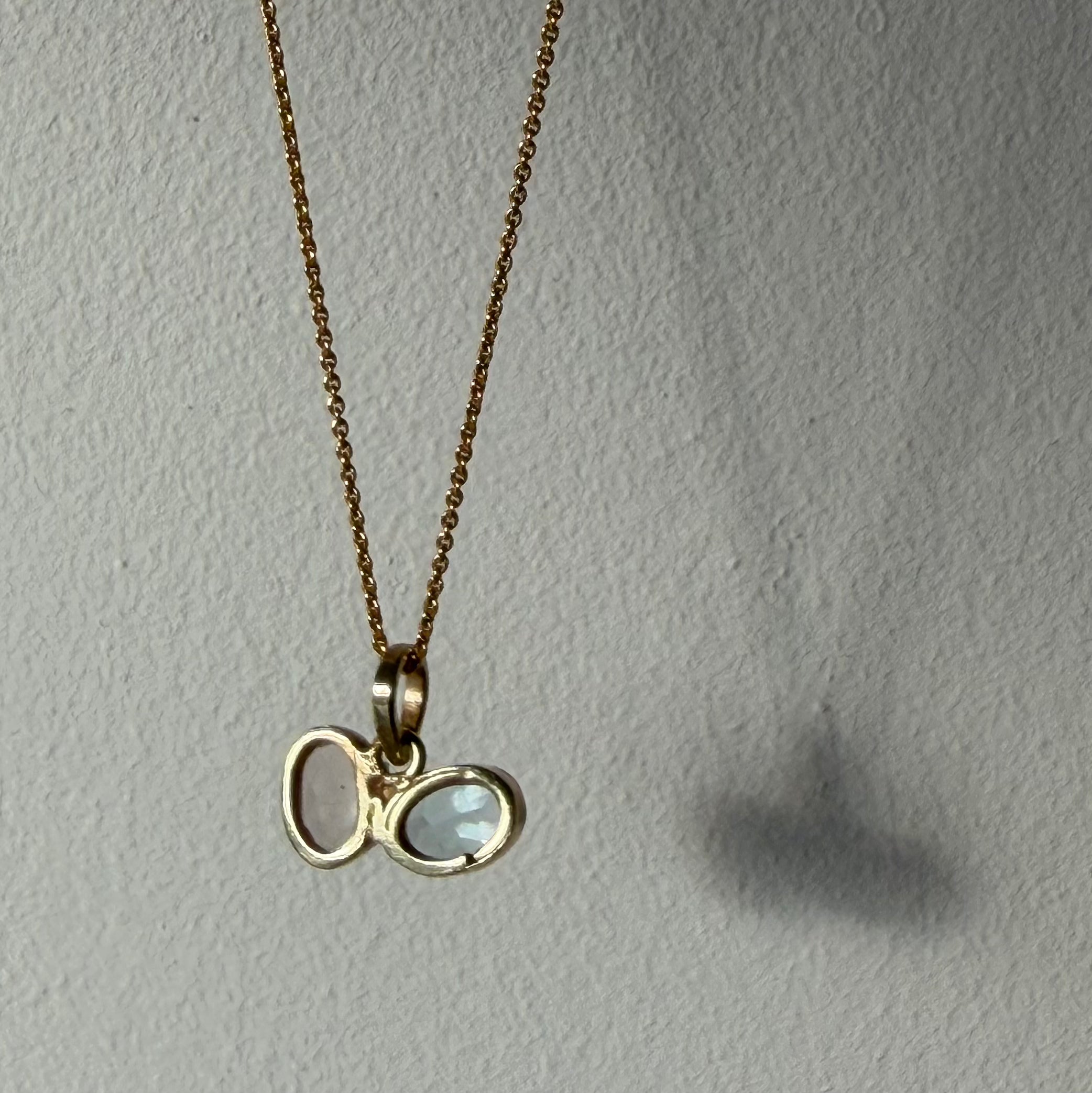 open back design of rose quartz and blue topaz gold gemstone pendant
