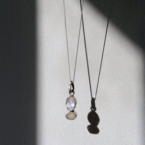 rose quartz and opal sterling silver pendant hanging in natural light