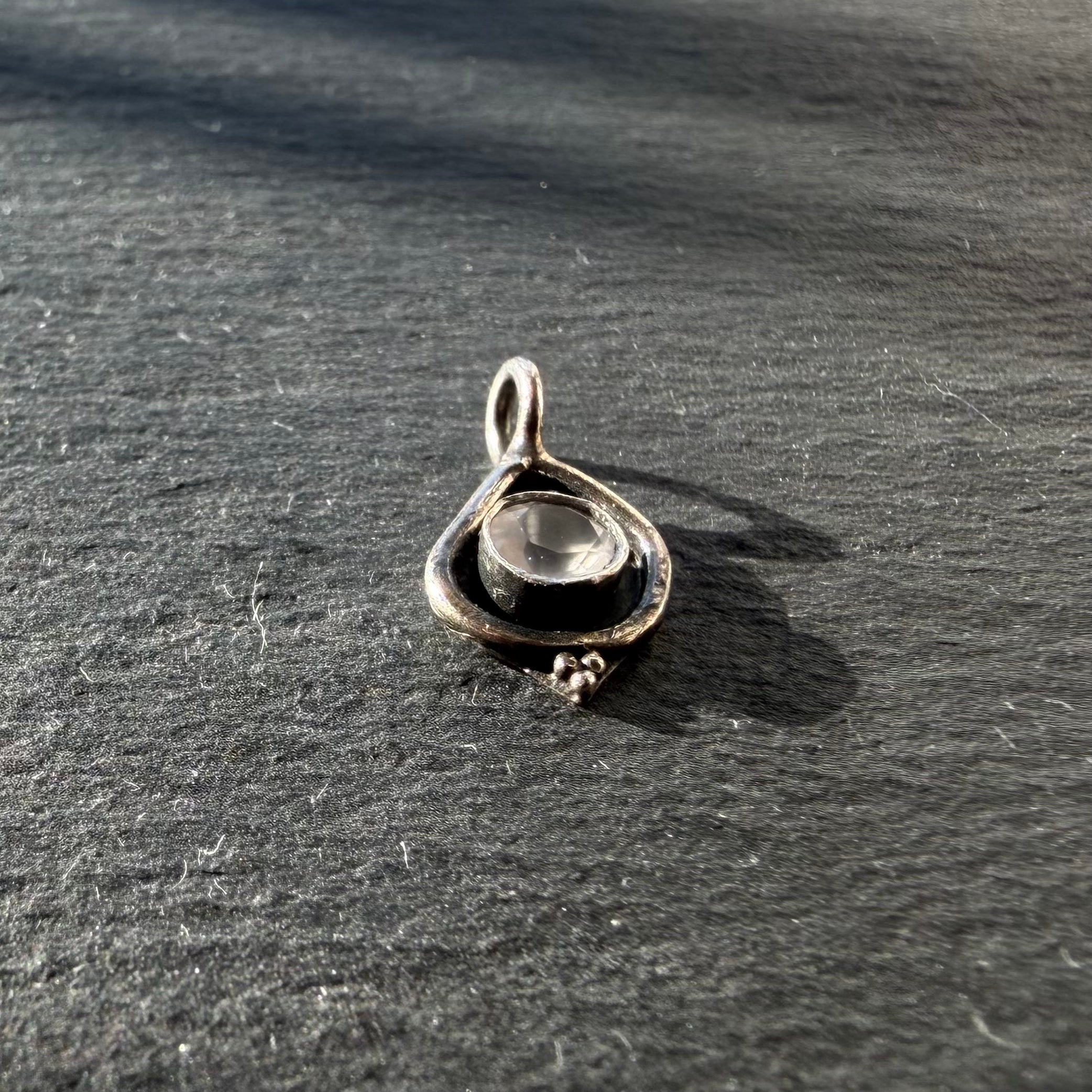 Side profile of sterling silver petite eye talisman pendant with rose quartz