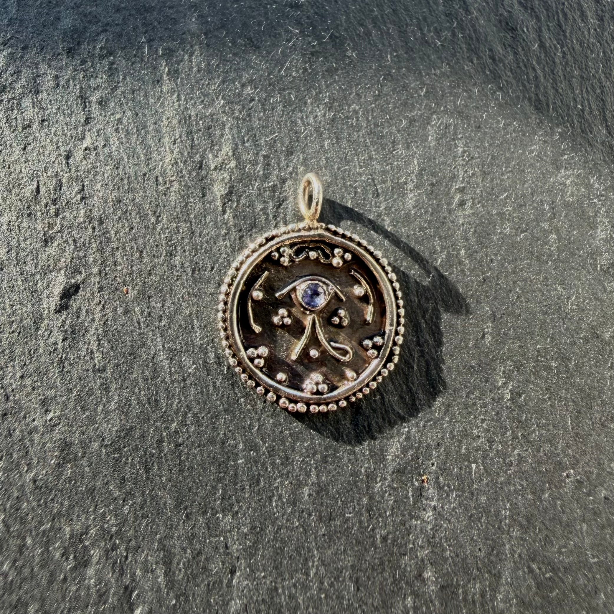 Handcrafted sterling silver Eye of Horus talisman pendant with tanzanite gemstone