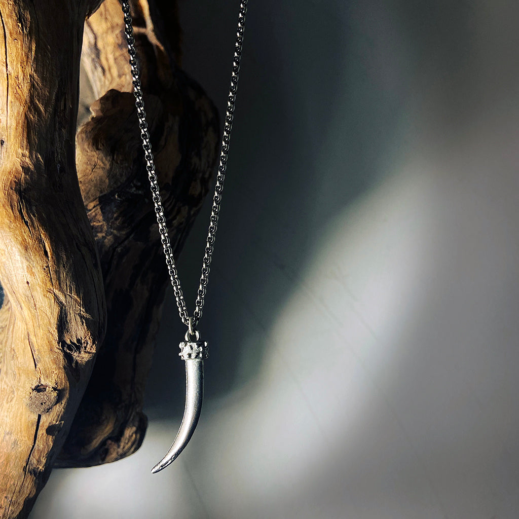 antique silver cast tusk pendant